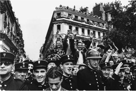 Crowds fill up the Champs-Élysées on August 26, 1944, to celebrate the liberation of Paris. Paris, France. 1944. ESTATE OF ROBERT CAPA